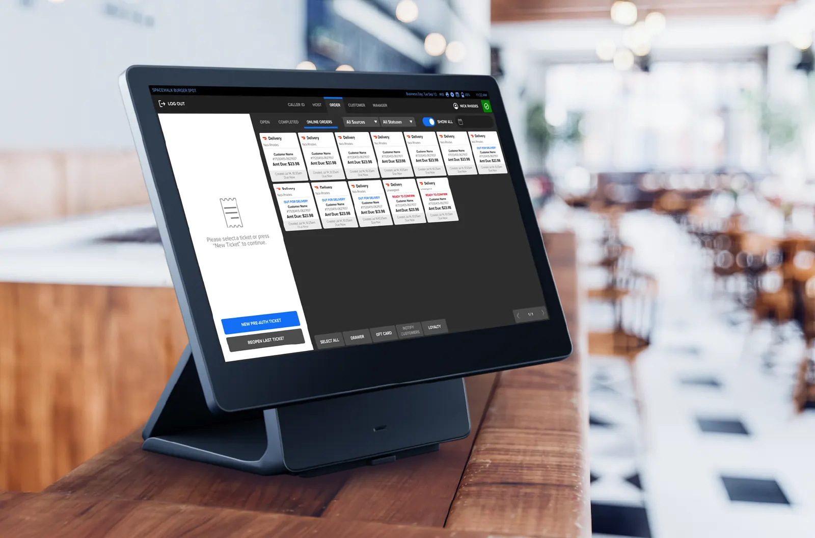Countertop POS tablet on a restaurant table showing a menu grid