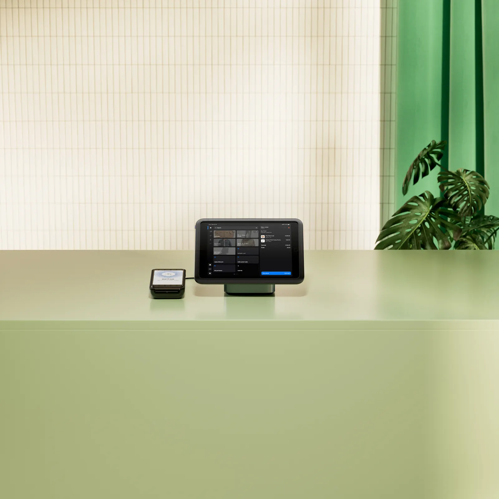 Countertop POS terminal and card reader on a pale green counter